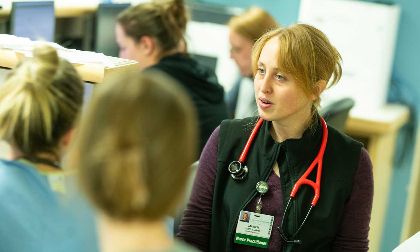 Nurse discusing monitor readings with another nurse